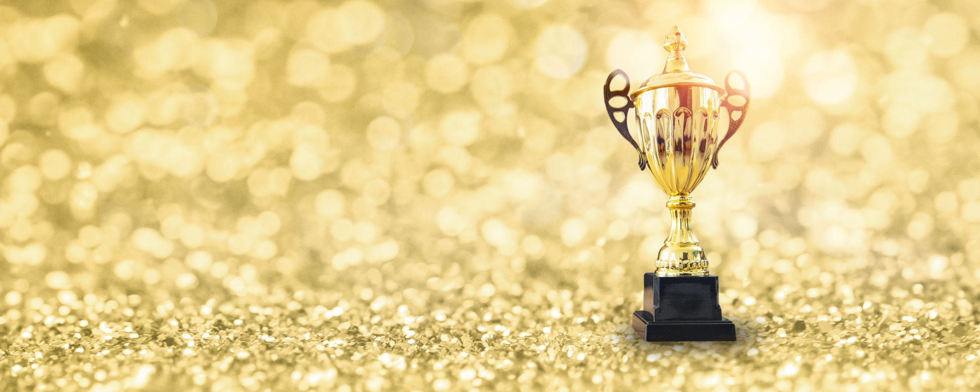 vecteezy_1st-champion-award-the-best-prize-and-winner-concept-championship-cup-or-winner-trophy-on-golden-floor-with-bokeh-background_2437431